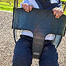 toddler, smiling, swing, playground, outdoor, sunny, child, happy, grass, fence, clothing, pants, socks, hands, face, head, daylight, nature, park, woodchips