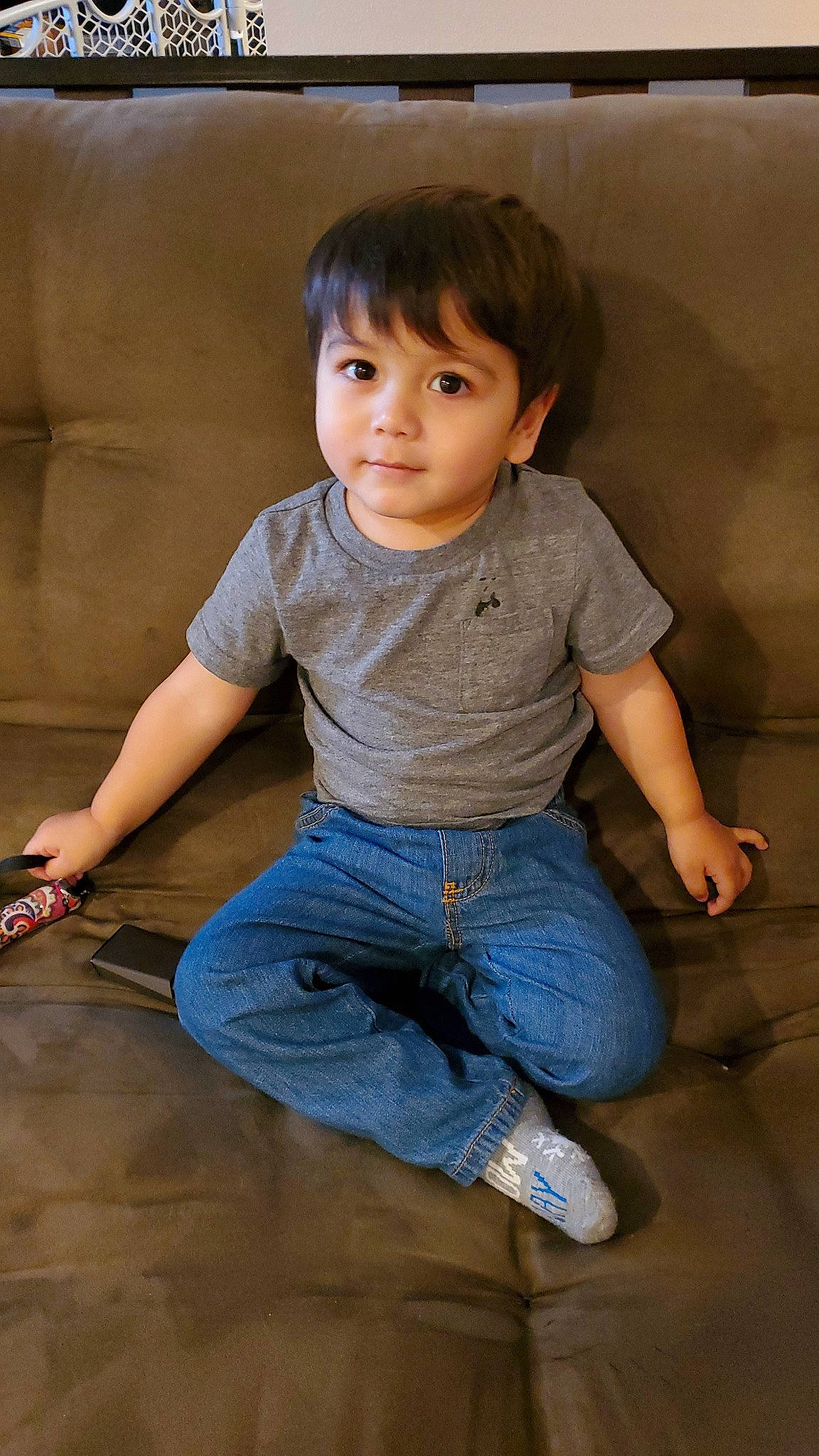 Ezra is registered to the contest to win money with this photo: cheek, child, child_model, denim, floor, jeans, leg, person, sitting, standing, toddler