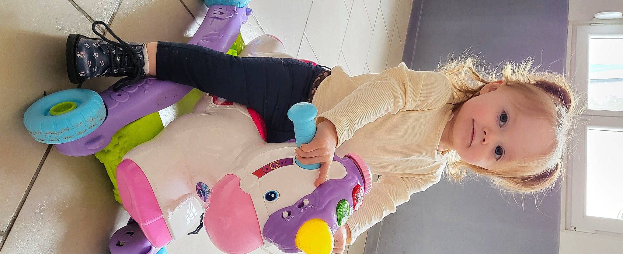 Kiara participe au concours pour gagner de l'argent avec cette photo : baby, baby_products, baby_toddler_clothing, child, happy, human_leg, knee, magenta, nail, person, pink, plush, room, sleeve, sock, stuffed_toy, textile, thigh, toddler, toy