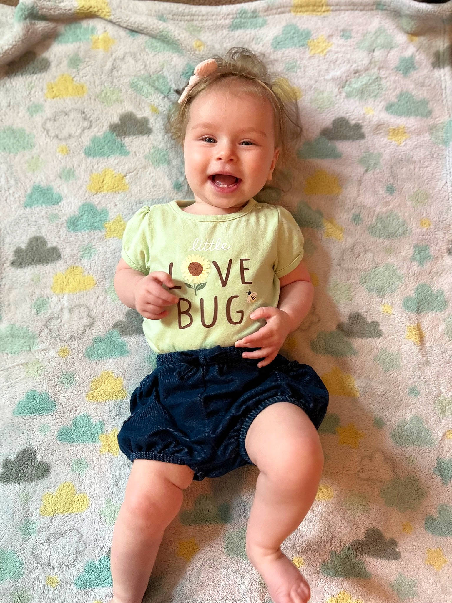 Miriam is registered to the contest to win money with this photo: baby, baby_toddler_clothing, barefoot, eye, face, hair, happy, head, human_body, pattern, person, pink, product, skin, sleeve, smile, t_shirt, textile, thigh, toddler