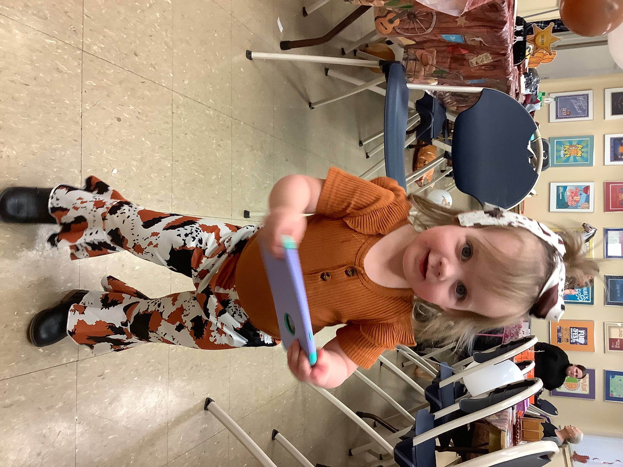 Ava is registered to the contest to win money with this photo: baby, child, elbow, eyewear, flooring, fun, hat, human_leg, knee, machine, person, room, smile, toddler, visual_arts, wood