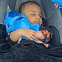 baby, sleeping, car_seat, plush_toy, blue, blanket, child, infant, cozy, peaceful, hands, clothing, cute, rest, indoor, soft, comfort, young, face, head