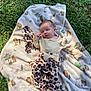 baby, sleeping, blanket, winnie_the_pooh, grass, outdoor, infant, clothing, patterned_pants, headband, nature, cute, peaceful, child, soft_texture, sunlight, portrait, person, resting, baby_girl