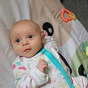 Lorelai joined the competition — help win amazing prizes! baby, infant, onesie, dinosaur_pattern, play_mat, blue_eyes, cute, indoor, carpet, child, soft_toys, colorful, sleepwear, lying_down, young_child, adorable, small_hand, looking_away, comfort, home