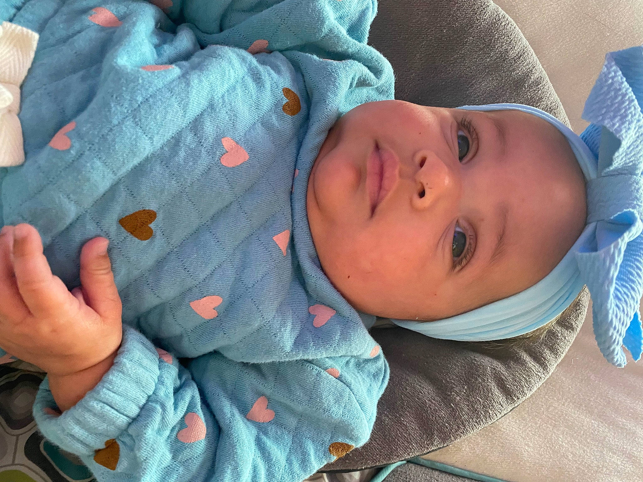 Ryleigh joined the competition — help win amazing prizes! baby, baby_products, baby_toddler_clothing, blue, cheek, child, comfort, eye, face, finger, gesture, head, headwear, linens, nose, person, product, skin, sleeve, thumb