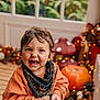 autumn, bandana, celebration, child, cozy, cute, decor, fairy_lights, fall, festive, happy, holiday, indoor, orange_sweater, portrait, pumpkin, smiling, toddler, window, wooden_floor