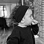 Andrea participe au concours pour gagner de l'argent avec cette photo : black_and_white, brick_wall, casual_clothing, child, cozy, curiosity, curly_hair, cute, floor, headband, home, indoor, person, portrait, profile, sweatshirt, thinking, thumb_sucking, toddler, young_child