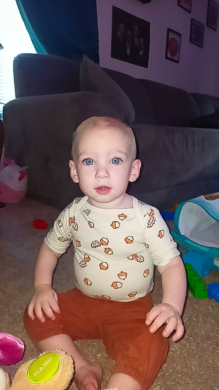 Marcellus is registered to the contest to win money with this photo: baby, baby_playing_with_toys, baby_toddler_clothing, baby_toys, chair, cheek, child, couch, eye, flooring, fun, mouth, person, picture_frame, play, room, sitting, sleeve, t_shirt, toddler