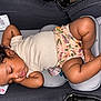 baby, sleeping, car_seat, curly_hair, infant, child, cute, relaxed, clothing, floral, shorts, skin, peaceful, rest, child_seat, indoors, young, person, comfort, nap
