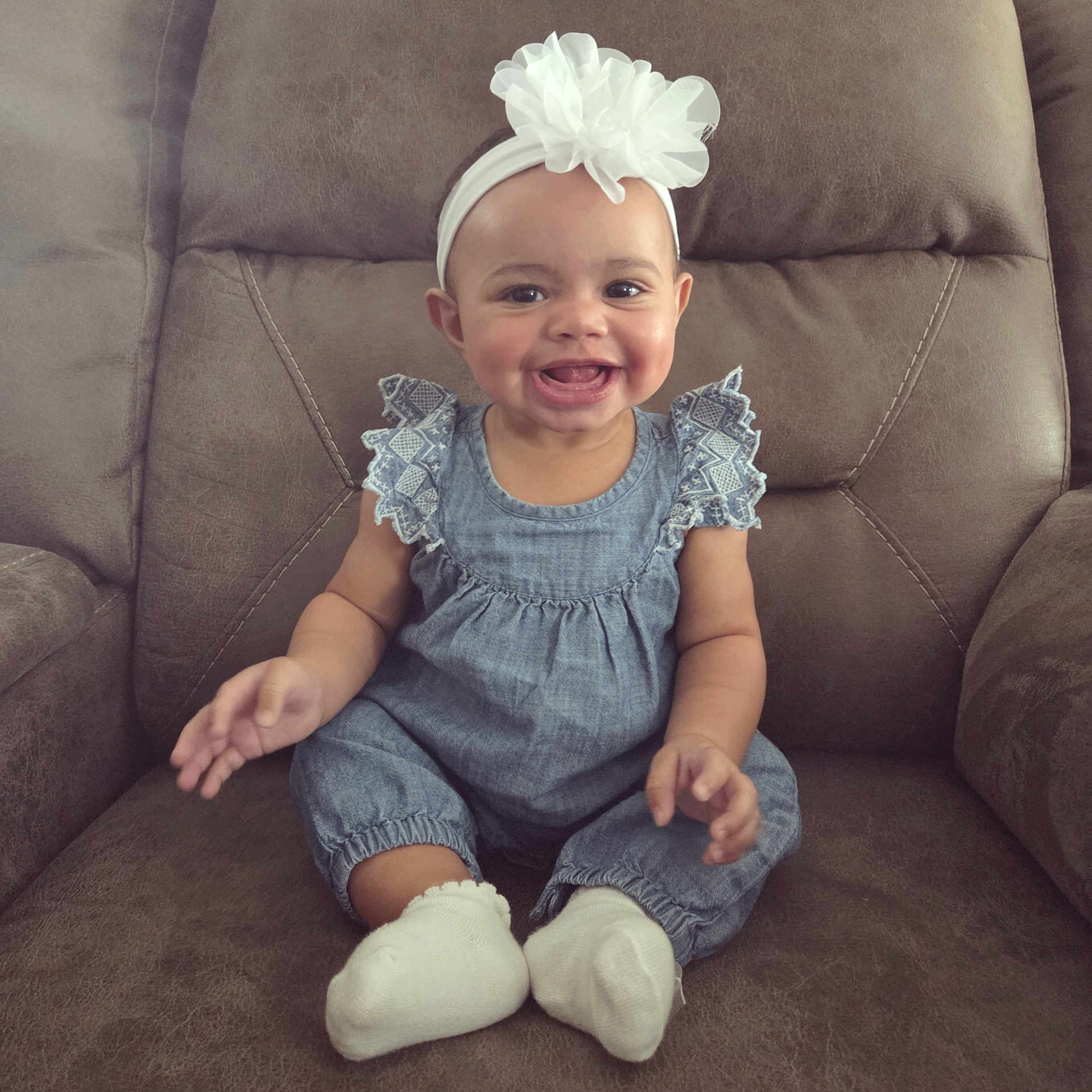 Lena is registered to the contest to win money with this photo: baby, chair, clothing, couch, cushion, face, furniture, happy, hat, head, homedecor, hosiery, jeans, pants, person, photography, portrait, sitting, smile, sock