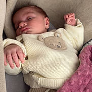 Nahïa participe au concours pour gagner de l'argent avec cette photo : baby, sleeping, knit_sweater, bear_patch, blanket, pink_blanket, cozy, infant, child, cute, peaceful, soft, seated, hand, face, head, clothing, fabric, texture, indoor