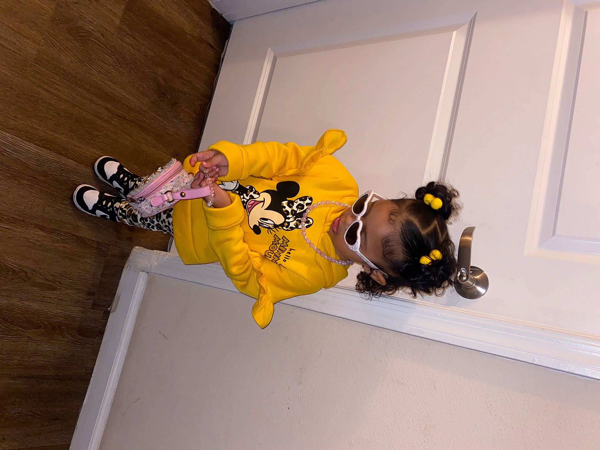 Ariella is registered to the contest to win money with this photo: floor, flooring, font, fun, hardwood, outdoor_shoe, person, personal_protective_equipment, recreation, room, sleeve, sports_uniform, t_shirt, toddler, wood