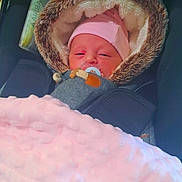 Célia a rejoint le concours — aidez-le/la à gagner de superbes lots ! newborn, baby, pacifier, blanket, car_seat, fur_hood, pink_hat, sleepy, infant, child, cozy, warm, soft_texture, closeup, portrait, indoors, airbag_tag, clothing, cute, person