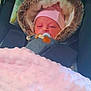 newborn, baby, pacifier, blanket, car_seat, fur_hood, pink_hat, sleepy, infant, child, cozy, warm, soft_texture, closeup, portrait, indoors, airbag_tag, clothing, cute, person