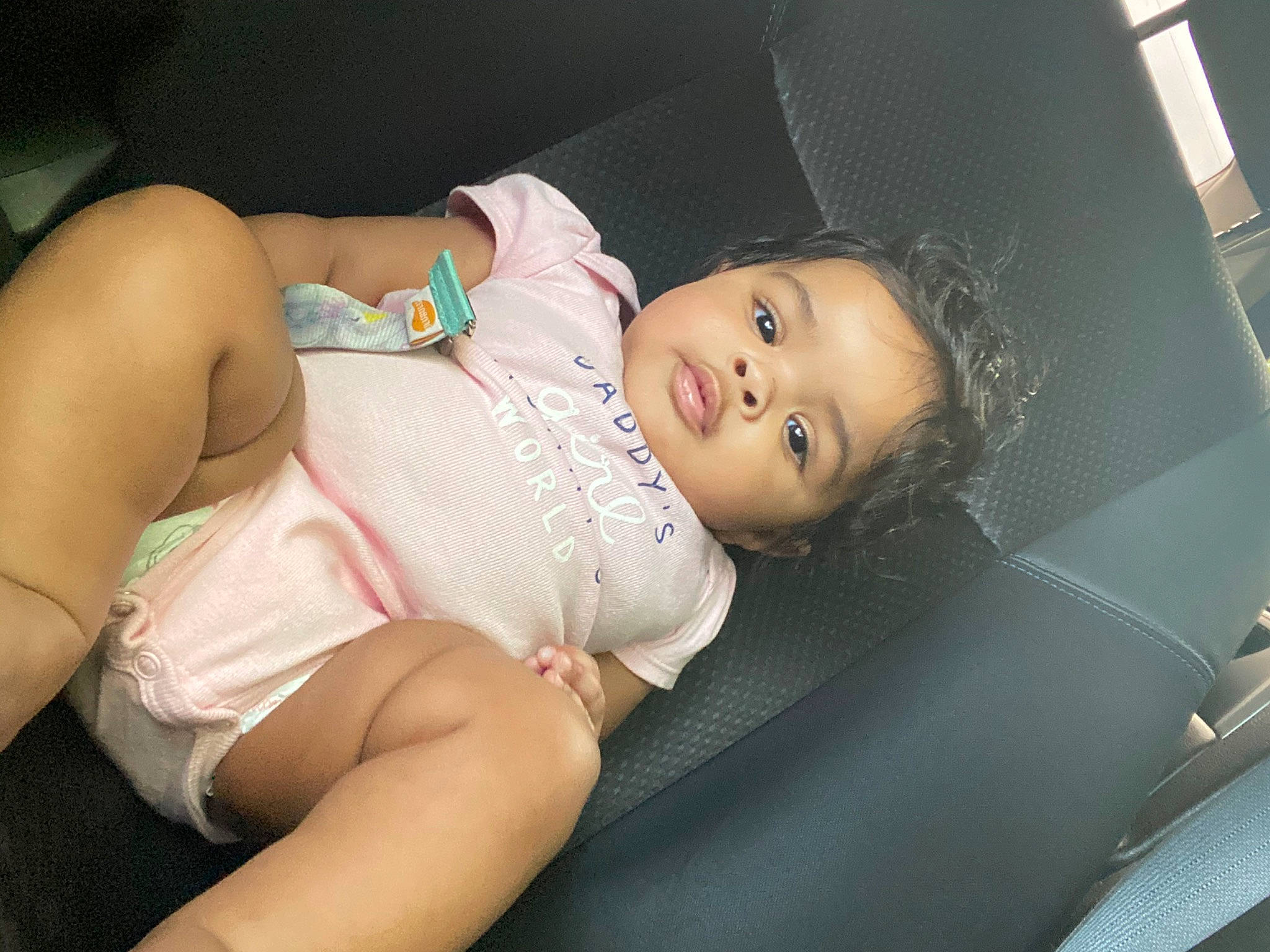 Kenzlie joined the competition — help win amazing prizes! baby, beauty, black_hair, car_seat, cheek, child, eye, leg, mouth, neck, person, pink, product, sitting, skin, smile, toddler, vacation