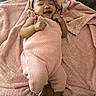 baby, blanket, bow, child, close_up, couch, cozy, cute, face, fashion, happy, headband, indoor, infant, knitwear, lying_down, pink_outfit, portrait, sandals, smiling