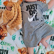 Kazdyn joined the competition — help win amazing prizes! baby, infant, child, blanket, plush_toy, soft_toy, onesie, clothing, face, hair, foot, hand, lying_down, pattern, cow_print, greenery, indoor, cute, curious, comfortable