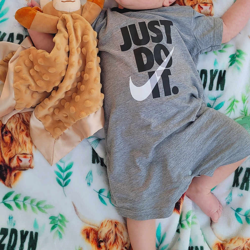 Kazdyn joined the competition — help win amazing prizes! baby, blanket, child, clothing, comfortable, cow_print, curious, cute, face, foot, greenery, hair, hand, indoor, infant, lying_down, onesie, pattern, plush_toy, soft_toy
