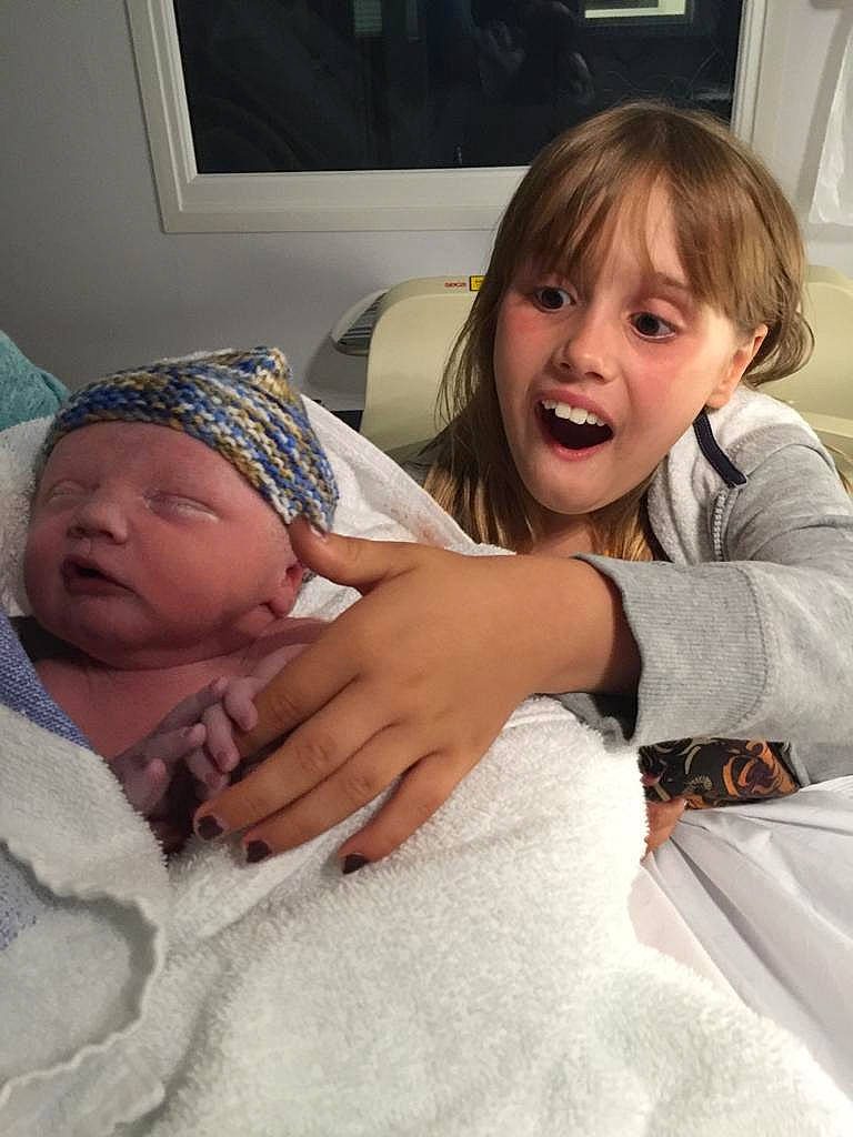 Aimee is registered to the contest to win money with this photo: arm, baby, birth, cheek, child, daughter, electronic_device, eye, face, facial_expression, fun, happy, head, headwear, linens, mother, people, person, skin, smile