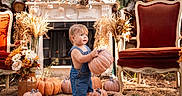 Hunter joined the competition — help win amazing prizes! autumn, baby, candid, child, denim_overalls, dried_wheat, fall_decor, family_photo, fireplace, flowers, harvest, ornate_chair, outdoor, portrait, pumpkin, pumpkin_patch, rustic, seasonal_decor, standing, toddler