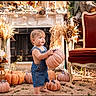 Hunter joined the competition — help win amazing prizes! child, toddler, baby, autumn, pumpkin, pumpkin_patch, denim_overalls, standing, outdoor, rustic, fall_decor, flowers, dried_wheat, ornate_chair, fireplace, harvest, portrait, candid, family_photo, seasonal_decor