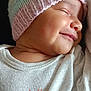 baby, infant, sleeping, smiling, knit_hat, pastel_colors, white_shirt, pumpkins, cute, peaceful, closeup, portrait, child, apparel, baby_clothes, face, skin, headwear, soft_light, dark_background
