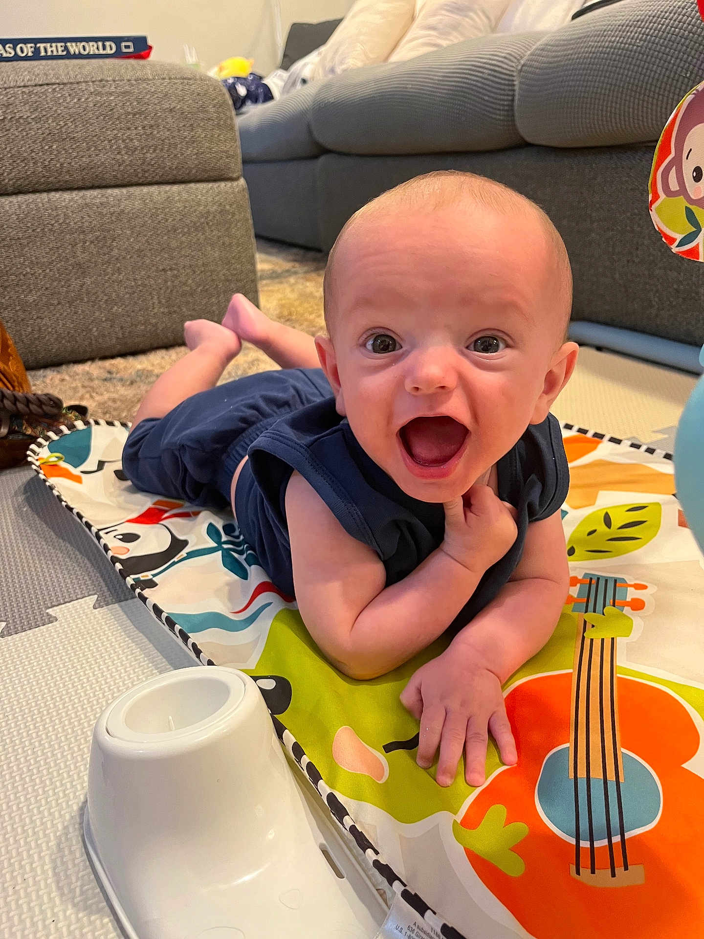 James joined the competition — help win amazing prizes! baby, infant, play_mat, smiling, indoor, colorful, toy, couch, carpet, happy, child, person, face, clothing, floor, home, expression, cute, small, toddler