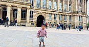 Gursher is registered to the contest to win money with this photo: architecture, building, casual_clothing, child, city, crowd, daytime, historic, hoodie, outdoor, pavement, people, playful, plaza, sandals, shorts, smiling, tourists, urban, walking