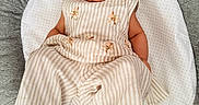 Tegh is registered to the contest to win money with this photo: baby, baby_girl, child, clothing, comfort, cushion, cute, fabric, floral_embroidery, happy, indoors, infant, person, portrait, relaxing, seat, smile, soft, striped_outfit, texture