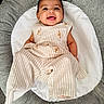 baby, baby_girl, child, clothing, comfort, cushion, cute, fabric, floral_embroidery, happy, indoors, infant, person, portrait, relaxing, seat, smile, soft, striped_outfit, texture