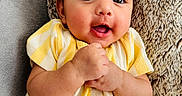 Tegh joined the competition — help win amazing prizes! baby, child, closeup, cozy, cute, eyes, face, hands_clasped, happy, indoor, infant, person, pillow, portrait, sitting, skin, smiling, soft_texture, striped_clothing, yellow_dress