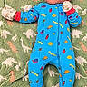 Cash joined the competition — help win amazing prizes! baby, infant, child, lying_down, portrait, face, wide_eyes, onesie, blue_clothing, mittens, dinosaur_blanket, blanket, indoors, close_up, baby_clothing, colorful, cute, looking_at_camera, textile, safe