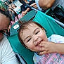 Aurora is registered to the contest to win money with this photo: adult, casual, child, clothing, crowd, daylight, event, glasses, hair, hand, happy, outdoor, people, person, portrait, seating, smile, spectators, stroller, toddler