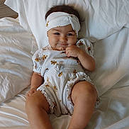 Aurora is registered to the contest to win money with this photo: baby, bed, bedroom, bodypart, clothing, couch, cushion, face, finger, furniture, hand, hat, head, homedecor, indoors, newborn, person, photography, portrait, room