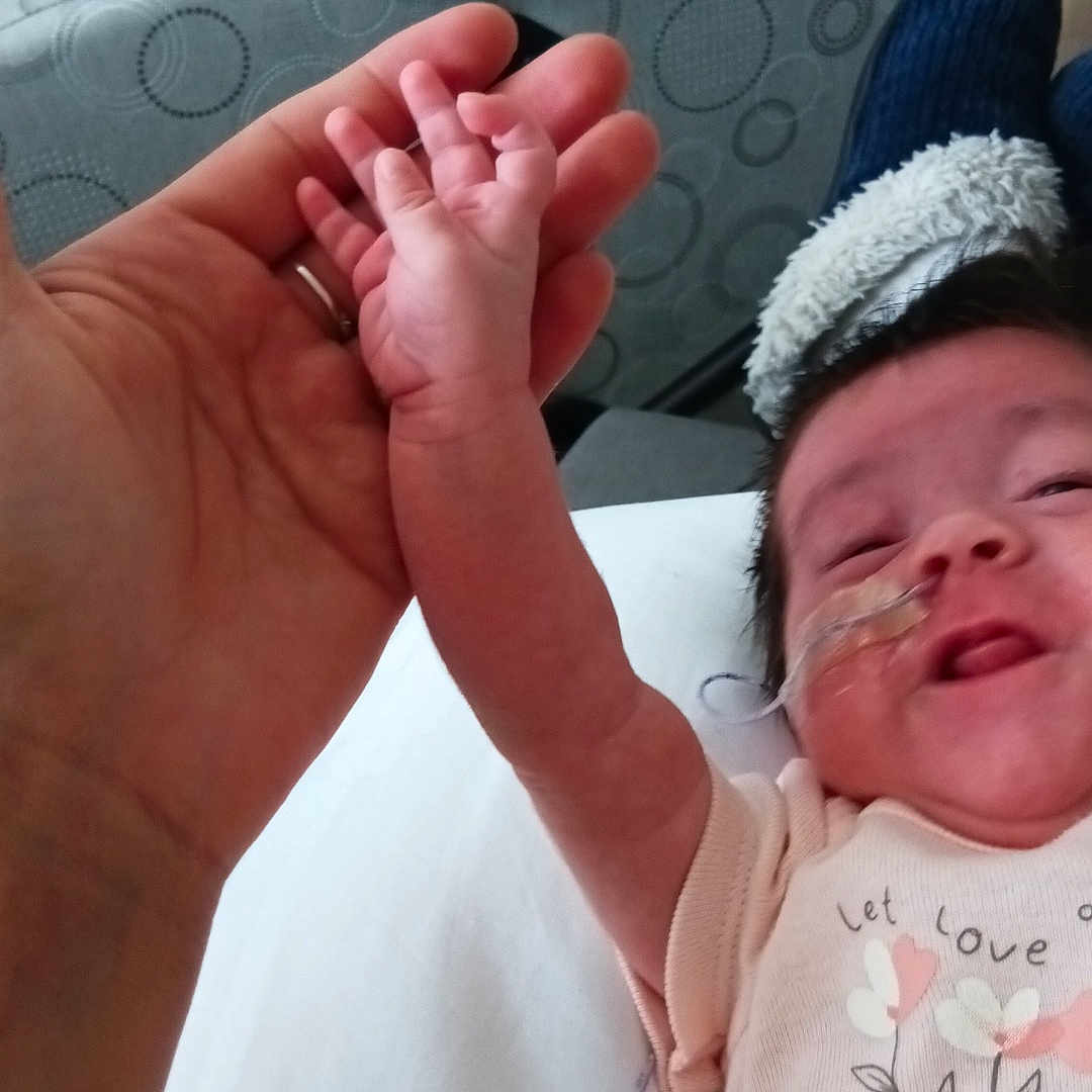 Sophia joined the competition — help win amazing prizes! adult_hand, baby, bed, blanket, care, chair, clothing, comfort, cute, expression, face, hand, holding_hands, hospital, infant, medical, medical_tape, nasal_tube, person, skin