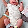Sophia is registered to the contest to win money with this photo: newborn, baby, infant, hospital, medical_devices, nasal_tube, onesie, blanket, person, arm, foot, monitoring_wires, hospital_band, resting, sleeping, healthcare, indoor, patient, adult, red_shoes