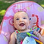 Meliiah is registered to the contest to win money with this photo: baby, blue_eyes, smiling, toy, baby_chair, colorful, outdoor, sunlight, happy, infant, clothing, sitting, closeup, face, child, play, cute, portrait, skin, hand