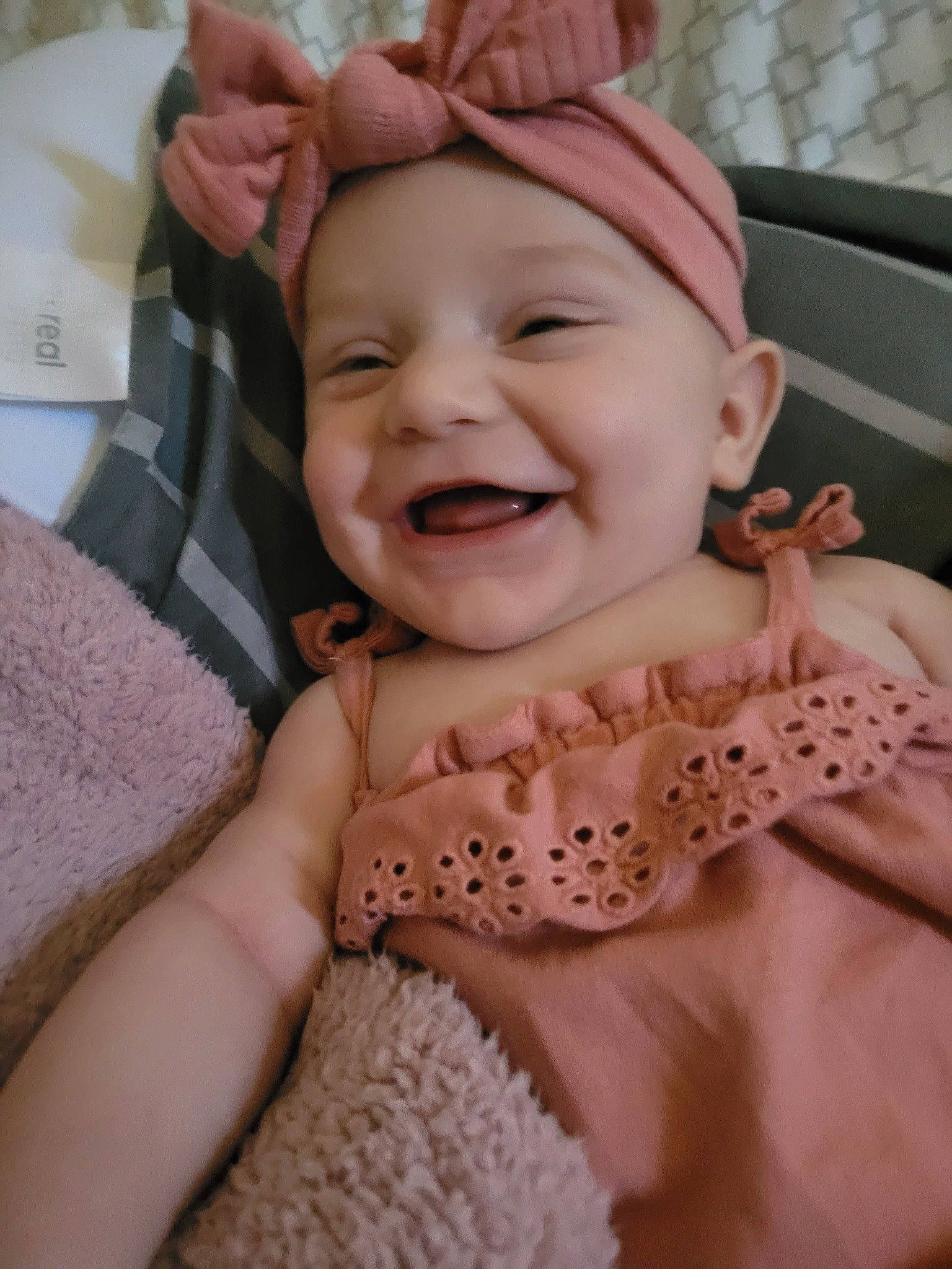 Zoè is registered to the contest to win money with this photo: arm, art, baby, cheek, eye, finger, forehead, gesture, happy, headwear, human_body, joy, lip, mouth, nail, nose, person, pink, skin, smile