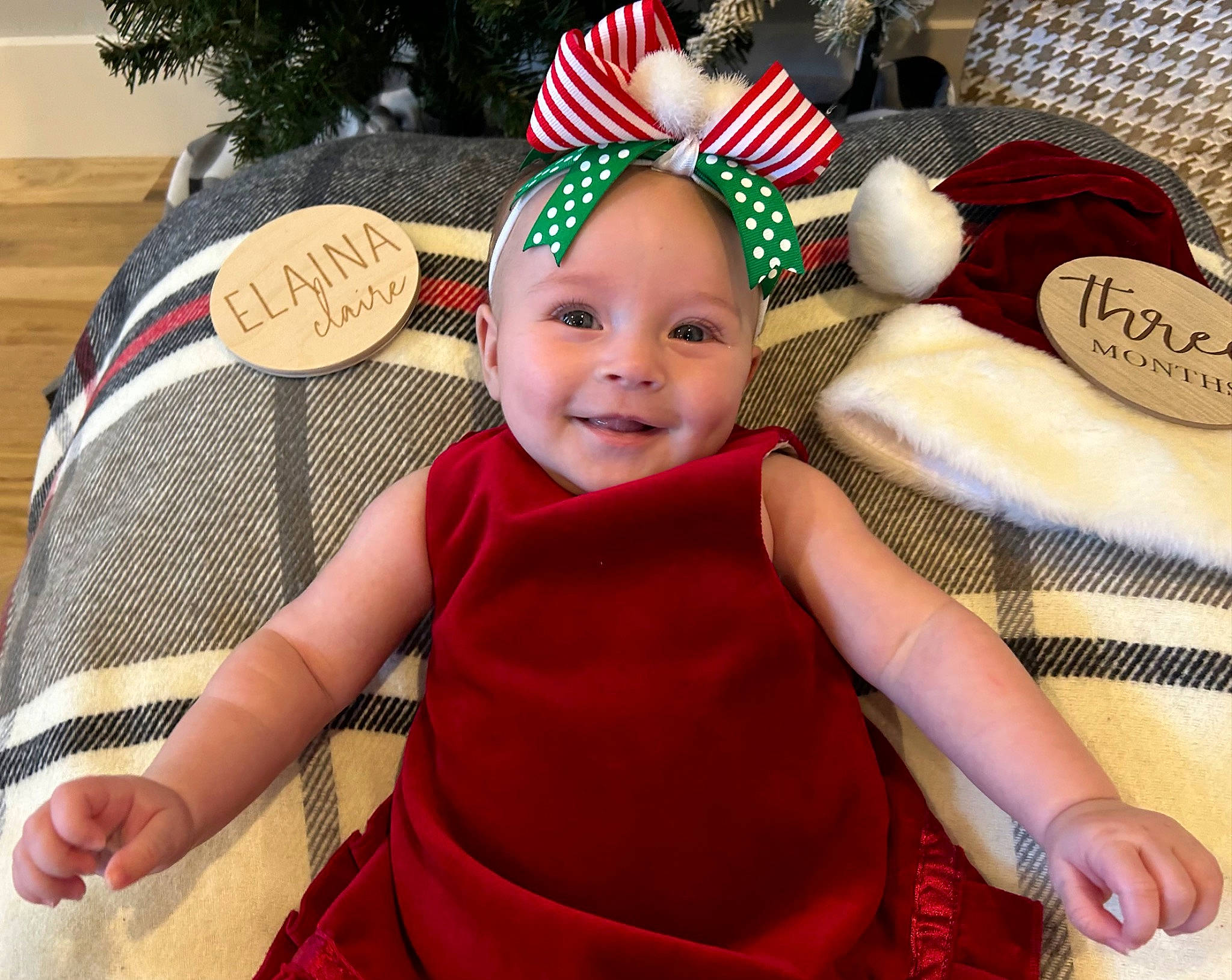Elaina is registered to the contest to win money with this photo: baby, baby_toddler_clothing, cap, chair, child, christmas_ornament, costume_hat, event, facial_expression, fun, happy, hat, head, holiday, joy, lap, person, pink, product, santa_claus