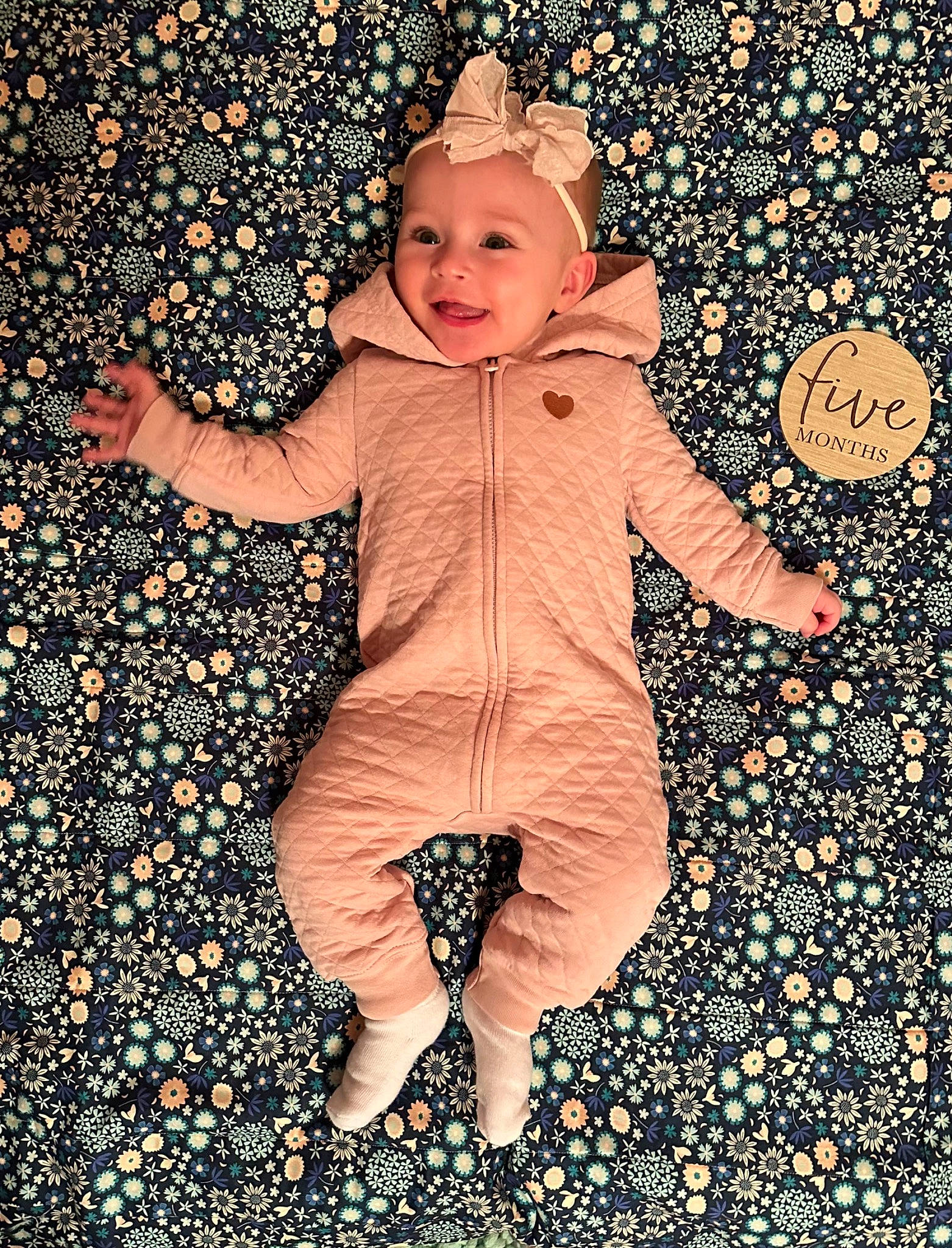 Elaina is registered to the contest to win money with this photo: baby, baby_toddler_clothing, cheek, child, eye, face, finger, flooring, fun, fur, gesture, happy, head, headwear, illustration, pattern, people_in_nature, person, play, sleeve