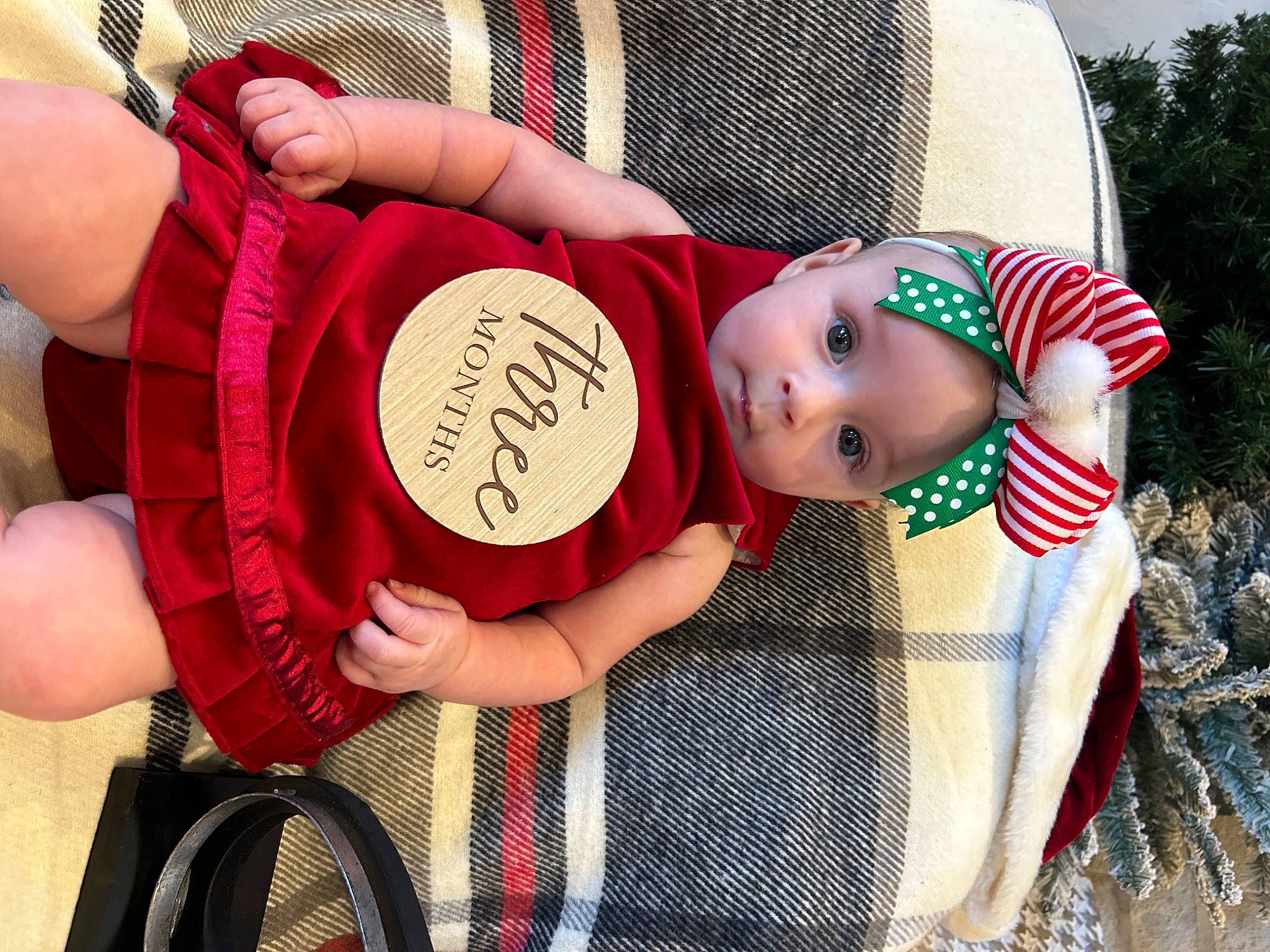 Elaina is registered to the contest to win money with this photo: baby, baby_toddler_clothing, child, facial_expression, fashion_accessory, fun, grass, hand, happy, hat, headgear, leg, pattern, person, pink, sitting, tire, toddler, toy, wheel