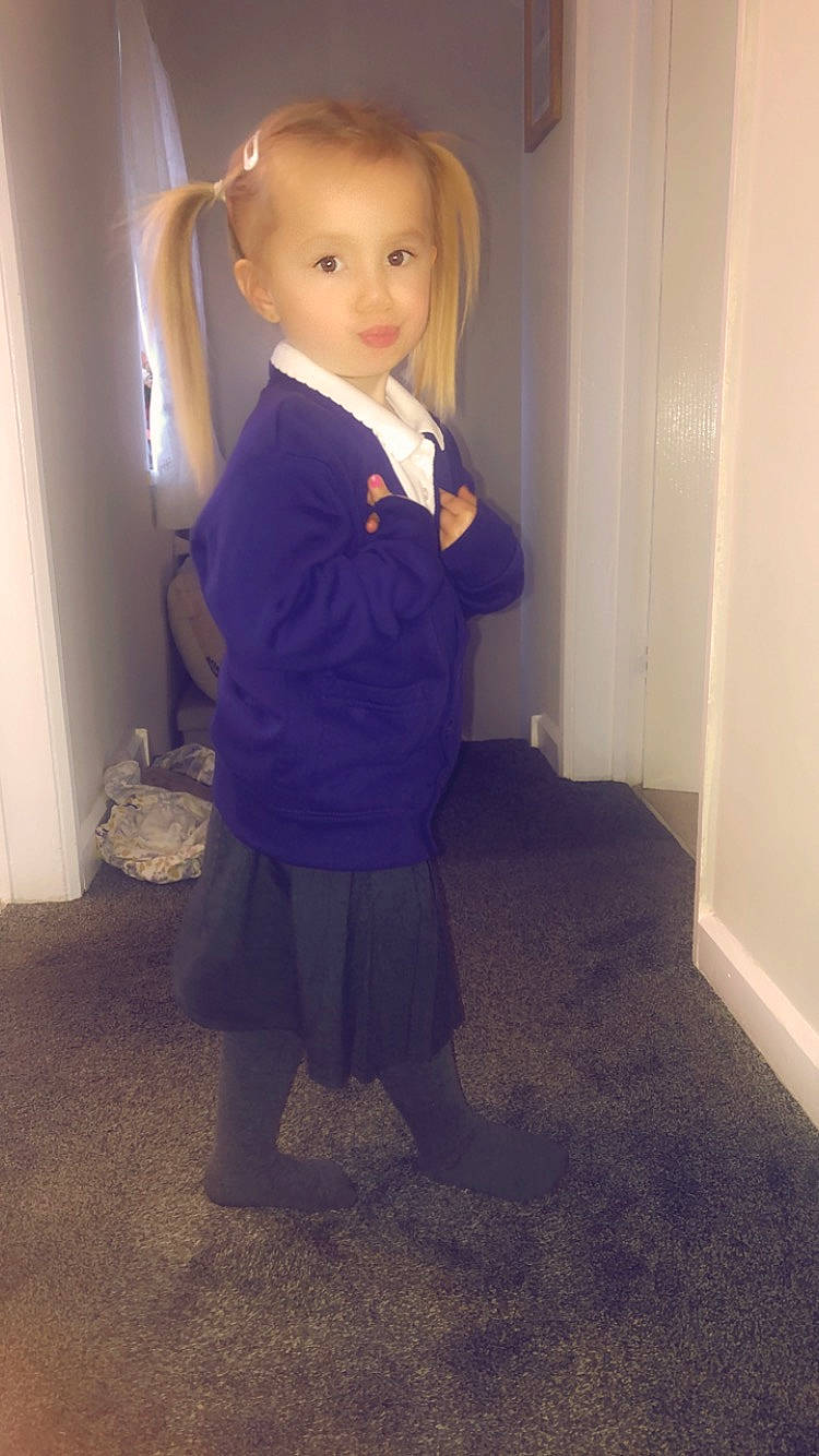 Lilly-mae is registered to the contest to win money with this photo: baby_toddler_clothing, blond, electric_blue, eye, floor, flooring, formal_wear, hair, head, iris, knee, leg, long_hair, neck, person, sleeve, standing, toddler, trunk, waist