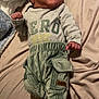 Andres joined the competition — help win amazing prizes! baby, infant, child, hat, corduroy, pants, blanket, bed, clothing, sleepwear, foot, hand, face, person, cute, lying_down, indoors, soft, warm, newborn