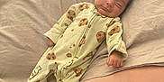 Andres joined the competition — help win amazing prizes! baby, infant, sleepwear, onesie, bed, blanket, pillow, sleeping, smiling, cute, child, indoor, soft, resting, cozy, person, face, human, cute_baby, peaceful