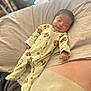 baby, infant, sleepwear, onesie, bed, blanket, pillow, sleeping, smiling, cute, child, indoor, soft, resting, cozy, person, face, human, cute_baby, peaceful