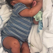 Andres is registered to the contest to win money with this photo: baby, blanket, blue_striped_onesie, child, cozy, cute, face, foot, hand, indoors, infant, newborn, pacifier, peaceful, portrait, resting, skin, sleeping, soft, wrapped