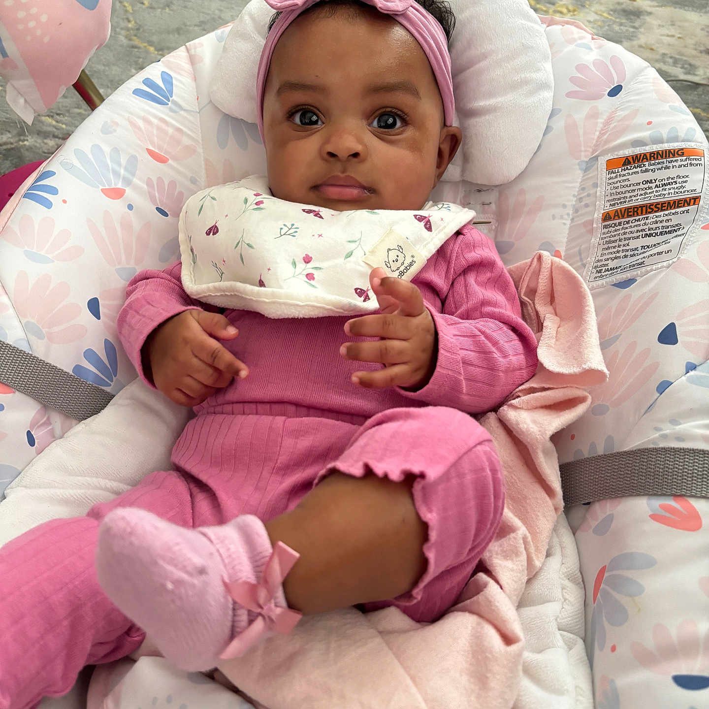 Alaiya is registered to the contest to win money with this photo: baby, infant, child, pink_clothing, headband, socks, baby_seat, blanket, indoor, curious_expression, cute, comfort, patterned_fabric, toddler, portrait, small_hands, soft_toys, floor, playtime, resting