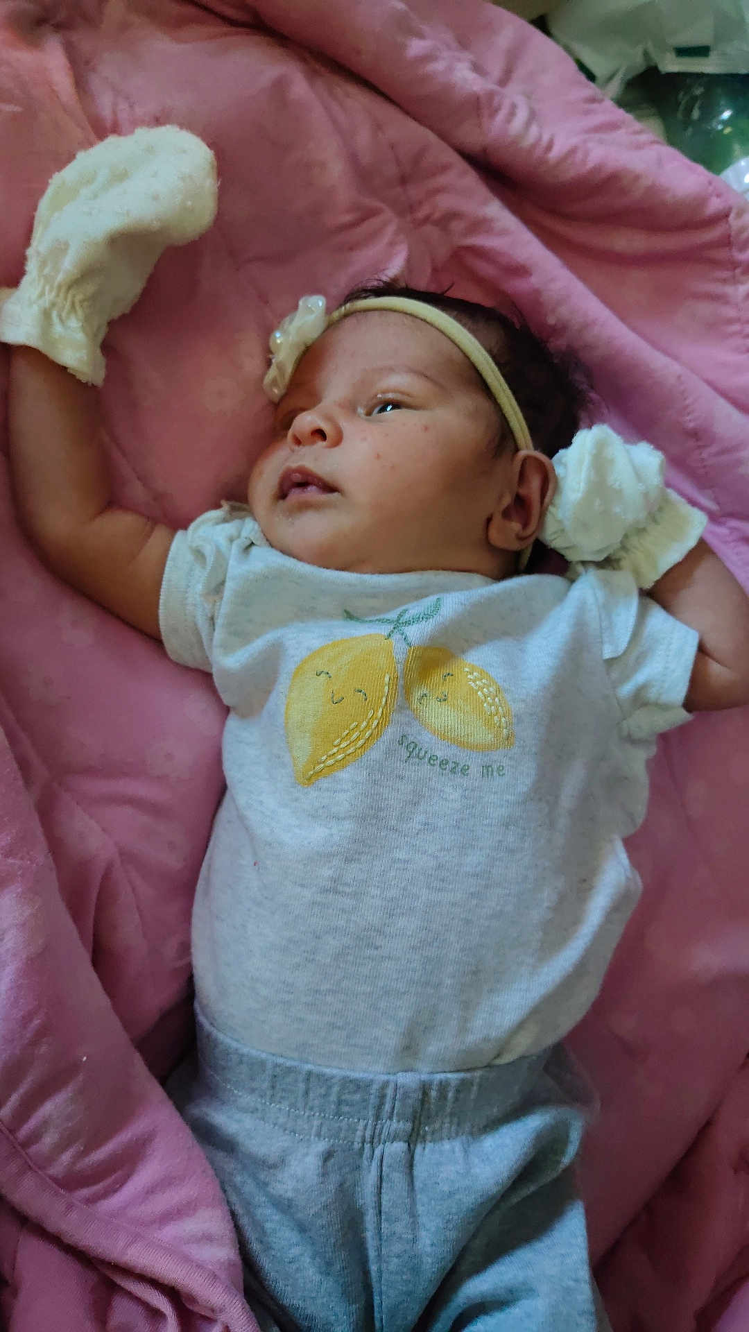 Zaloni is registered to the contest to win money with this photo: baby, infant, blanket, pink, mittens, headband, clothing, tshirt, pants, laying, portrait, face, person, cute, soft, indoor, relaxed, young, sleepy, resting