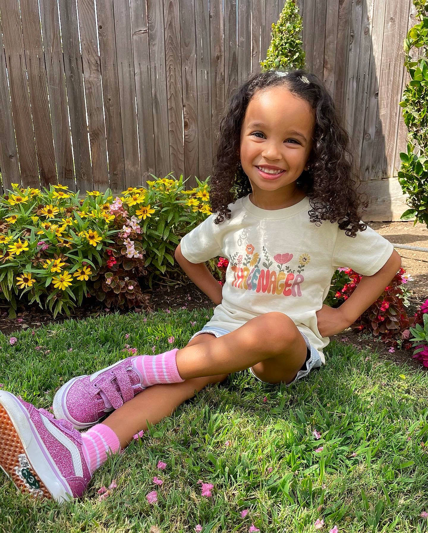 Ovie is registered to the contest to win money with this photo: clothing, facial_expression, flower, grass, grass_family, groundcover, hairstyle, happy, human_body, joy, leisure, people_in_nature, person, pink, plant, shrub, skin, smile, summer, thigh