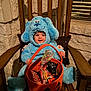 toddler, child, costume, blue_dog, halloween, candy, basket, pumpkin, chair, wooden, smile, indoors, window, stone_wall, pillow, cute, holiday, celebration, fun, festive